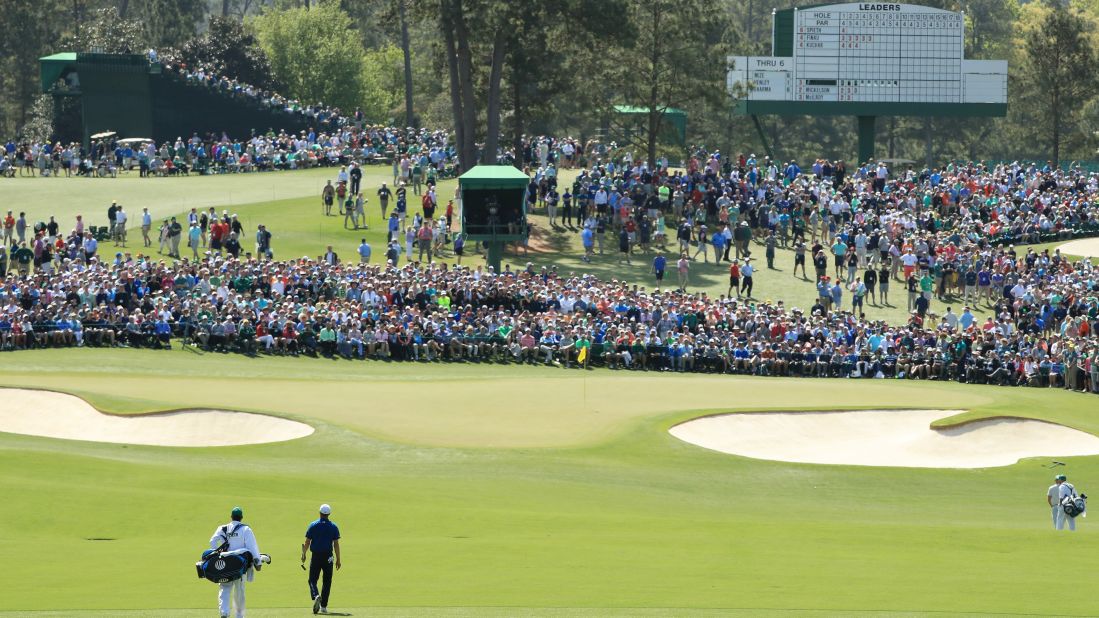 Jordan Spieth and his caddie, Michael Greller, walk down the second fairway on Friday.