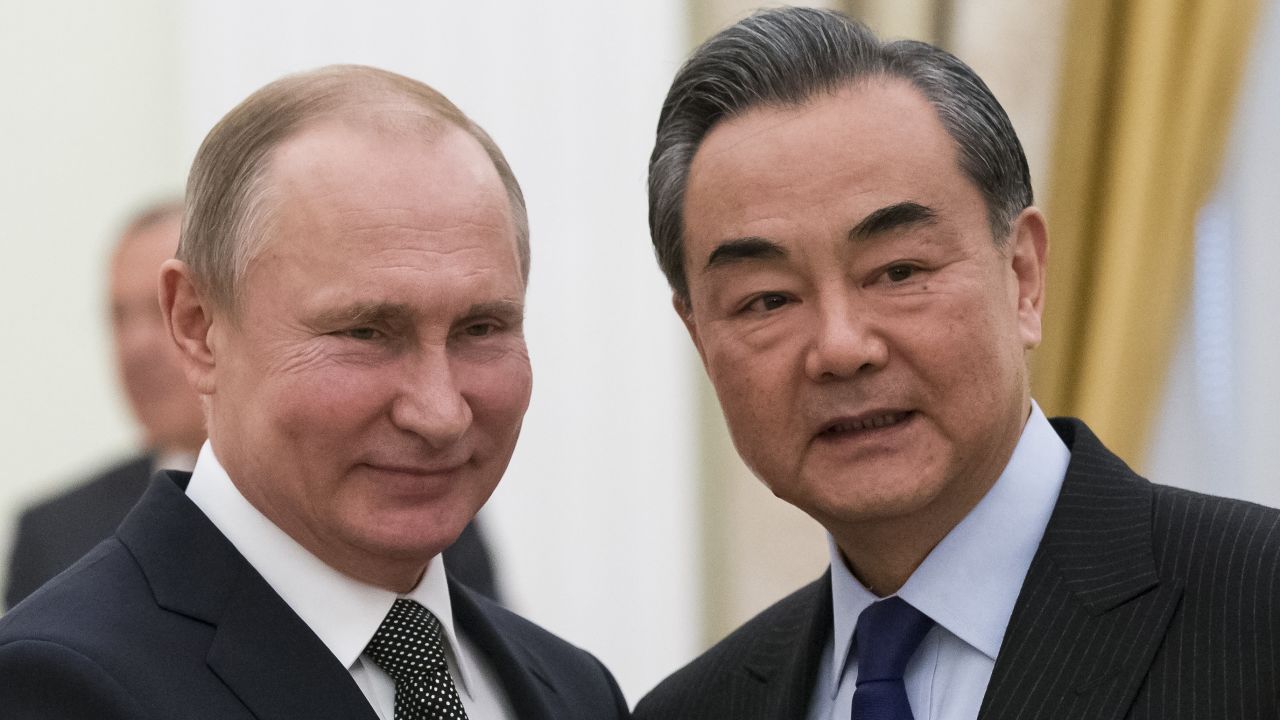 Russian President Vladimir Putin shakes hands with Chinese Foreign Minister Wang Yi during a meeting at the Kremlin in Moscow on April 5.
