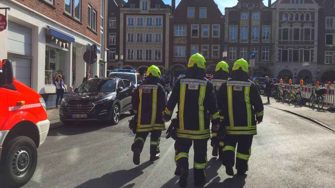 Firefighters walk through downtown Muenster, Germany, on Saturday after a vehicle drove into a crowd. 