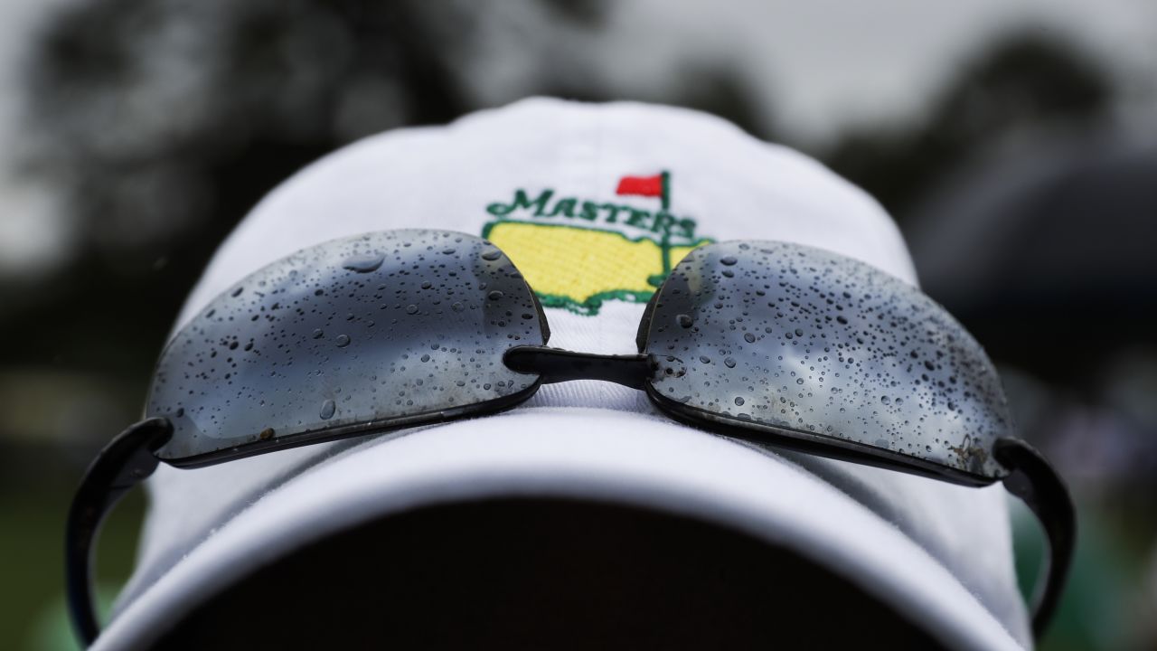 A fan watches from the second hole during the third round at the Masters golf tournament Saturday. 