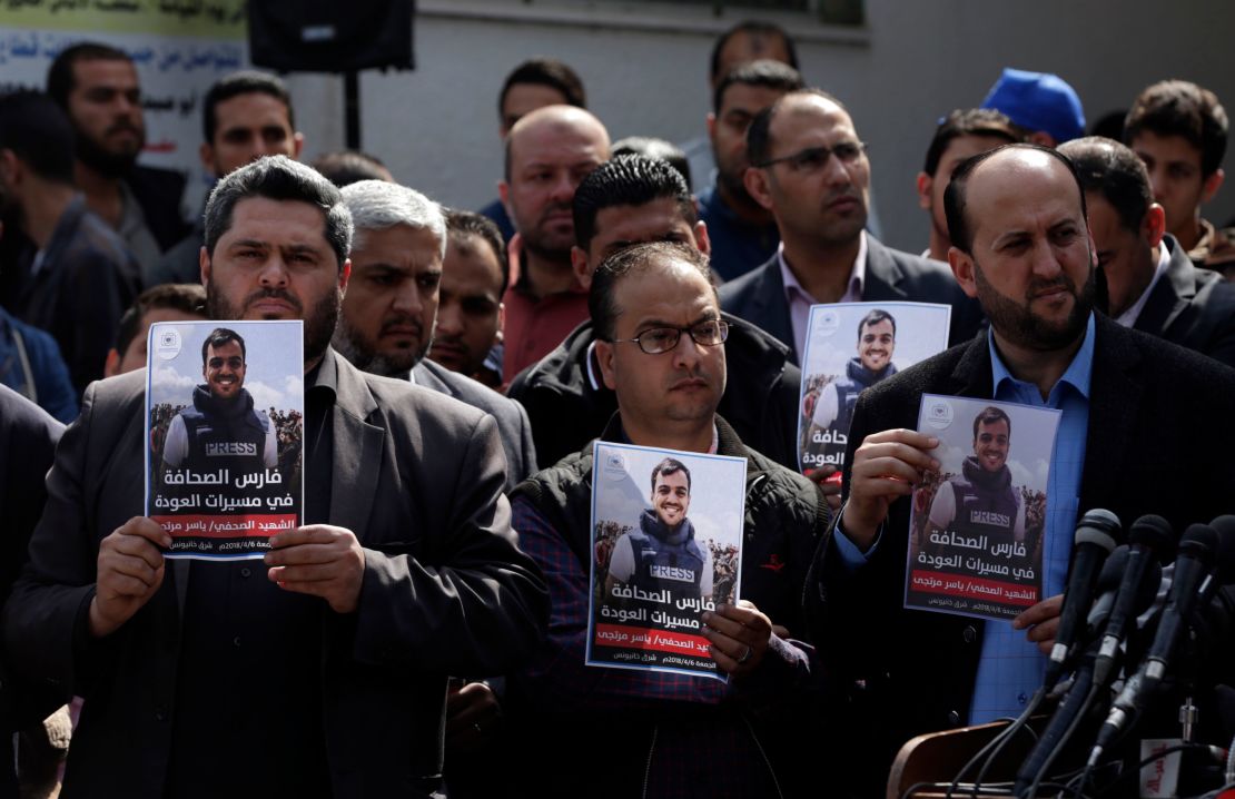 Palestinian journalists carry a portrait of a journalist during his funeral on Saturday.