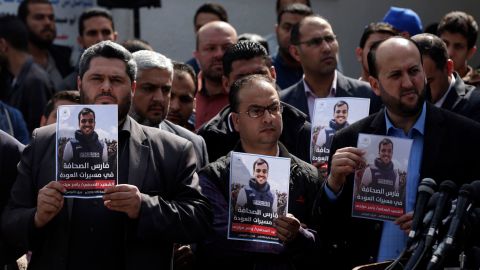 Palestinian journalists carry a portrait of a journalist during his funeral on Saturday.