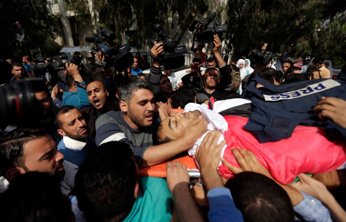 Mourners carry the body of a Palestinian journalist during his funeral Saturday in Gaza City.