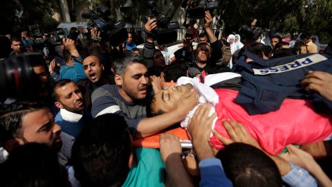 Mourners carry the body of a Palestinian journalist during his funeral Saturday in Gaza City.