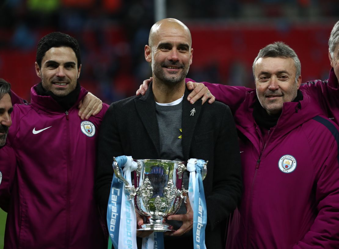 Guardiola and his staff celebrate after winning the Carabao Cup Final against Arsenal.