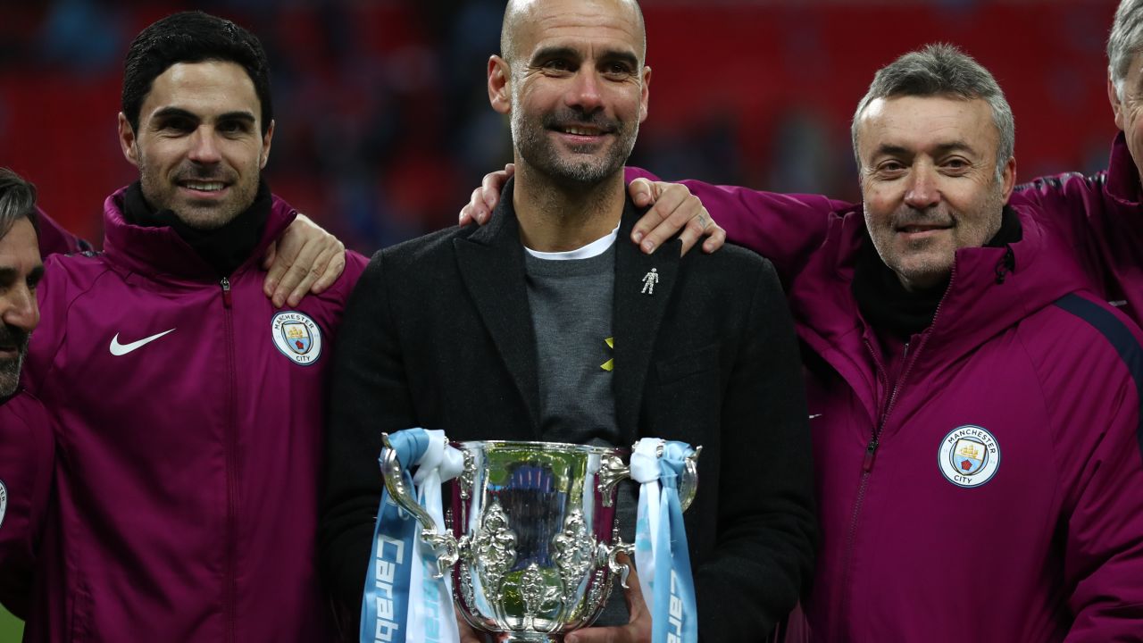 Guardiola and his staff celebrate after winning the Carabao Cup Final against Arsenal.