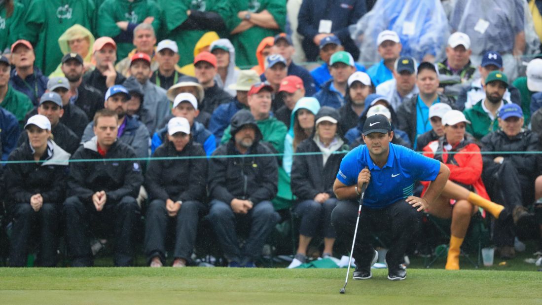 Patrick Reed lines up a putt on the 18th green during the third round of the 2018 Masters Tournament at Augusta National Golf Club on Saturday. 