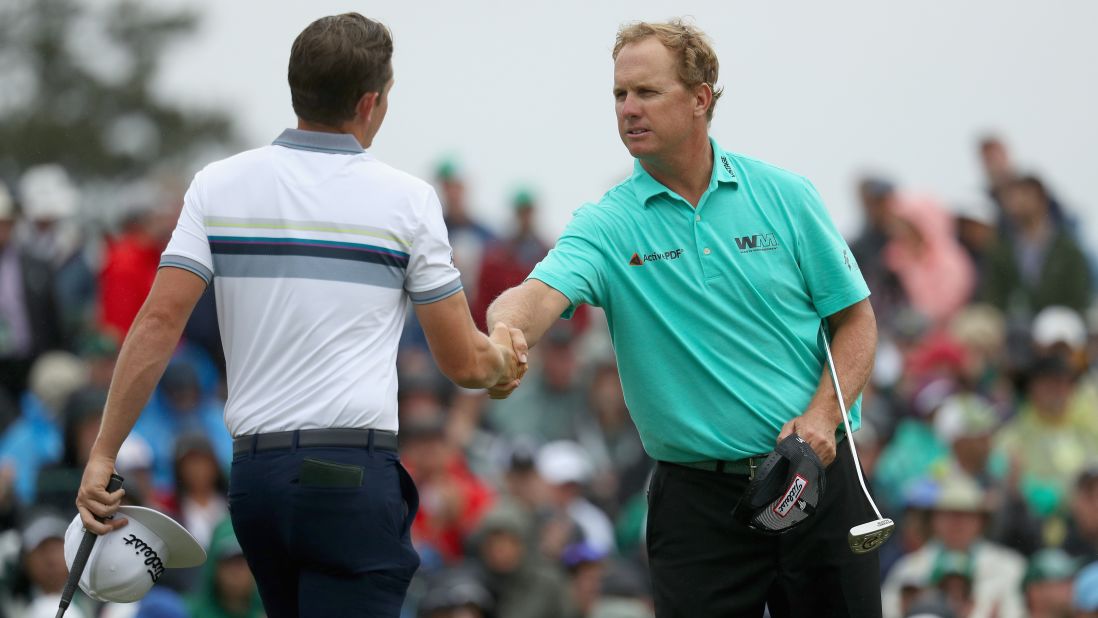 Charley Hoffman and Cameron Smith shake hands on the 18th green during the third round of the 2018 Masters Tournament at Augusta National Golf Club on Saturday. 