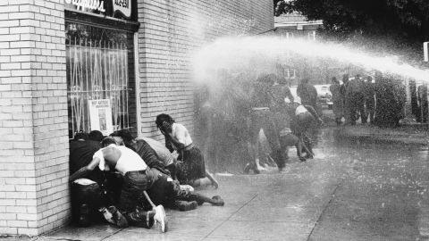 Black protesters came under attack by dogs and water cannons in 1963. Activists say there's a link between those protests and Birmingham's efforts to raise the minimum wage.