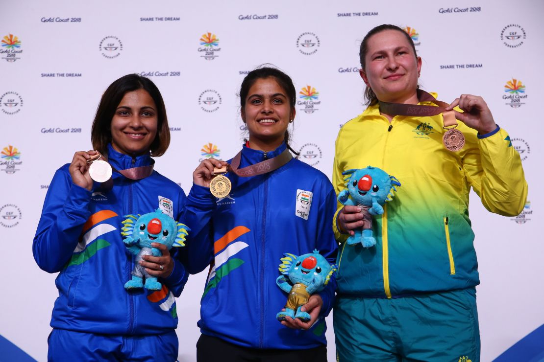 Gold medalist Manu Bhaker, center, with India's silver medalist Heena Sidu, left, and  Australia's bronze medalist Elena Galiabovitch. 