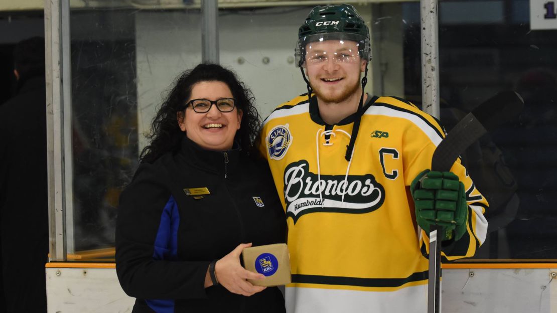 Logan Schatz, right, receives the player of the month award for February.