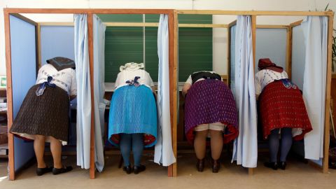 Women dressed in traditional Hungarian outfits cast their votes.  