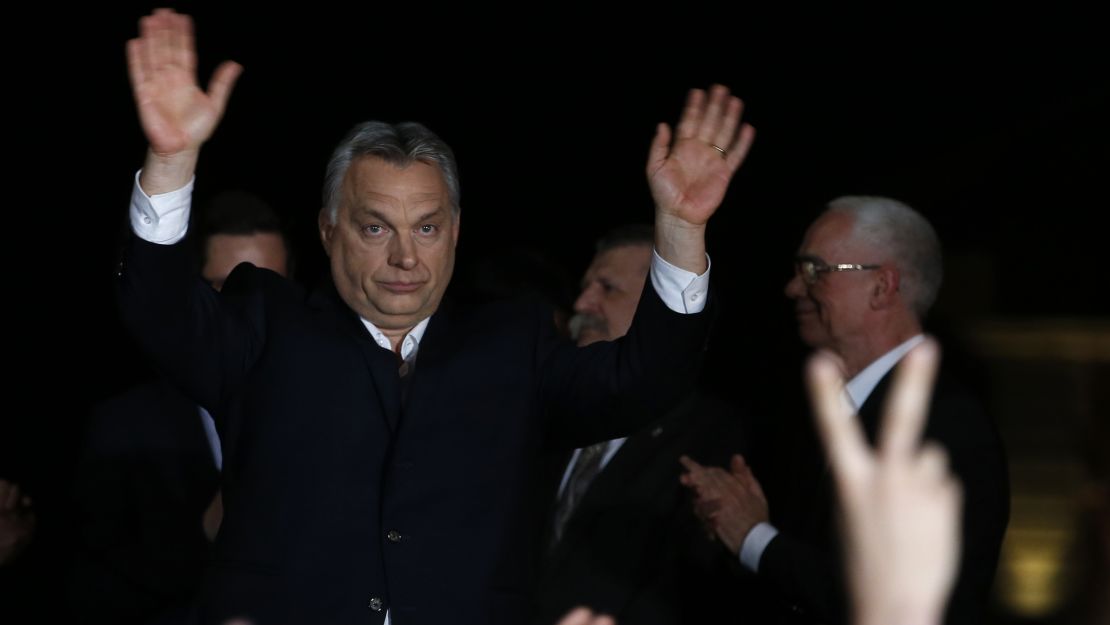 Orban greets supporters in Budapest on Sunday.