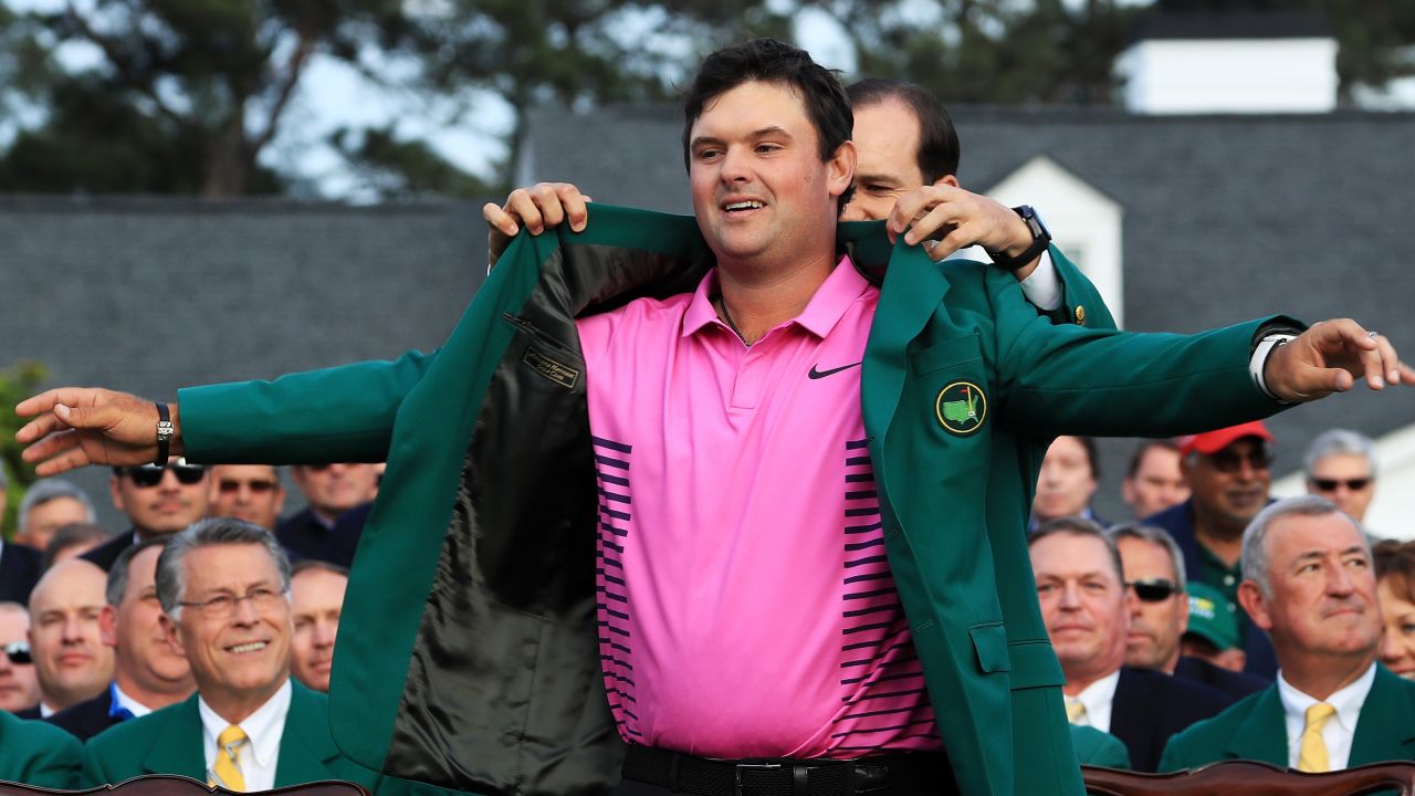Patrick Reed is awarded the Green Jacket by 2017 winner Sergio Garcia of Spain after winning the Masters at Augusta.
