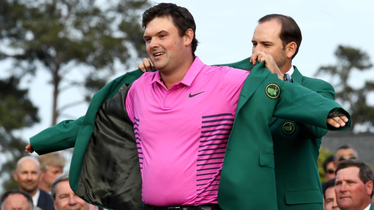 Patrick Reed is presented with the green jacket by Sergio Garcia during the green jacket ceremony on Sunday. 