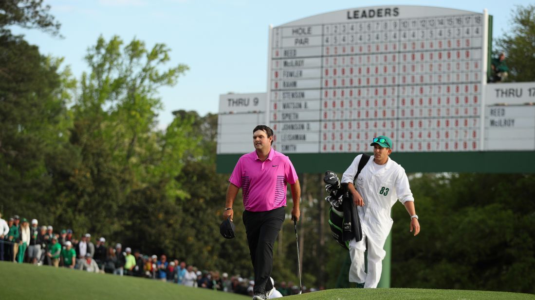 Patrick Reed walks onto the 18th green with caddie Kessler Karain during the final round on Sunday. 