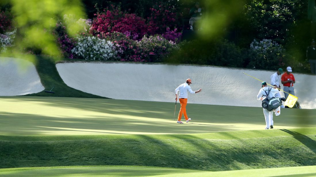 Rickie Fowler waves on the 13th green. 