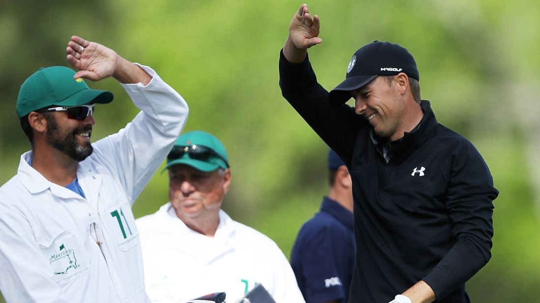 Jordan Spieth reacts on the 12th tee with caddie Michael Greller.