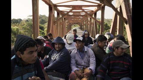 Central American migrants ride a freight train in Matias Romero on Sunday, April 1.