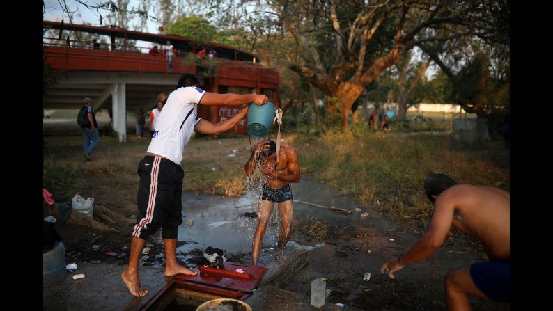 Men take bucket showers at a sports club in Matias Romero on April 4.