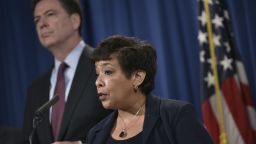 US Attorney General Loretta Lynch (C) speaks during a press conference at the Department of Justice on March 24, 2016 in Washington, DC.  At left is FBI Director James Comey.
Lynch announced the unsealing of an indictment of seven Iranians on computer hacking charges.  / AFP / Mandel Ngan        (Photo credit should read MANDEL NGAN/AFP/Getty Images)
