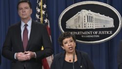 US Attorney General Loretta Lynch (C) speaks during a press conference at the Department of Justice on March 24, 2016 in Washington, DC. 
Lynch announced the unsealing of an indictment of seven Iranians on computer hacking charges. Flanking Lynch are FBI Director James Comey (L) and US Attorney of the Southern District of New York Preet Bharara. / AFP / MANDEL NGAN        (Photo credit should read MANDEL NGAN/AFP/Getty Images)