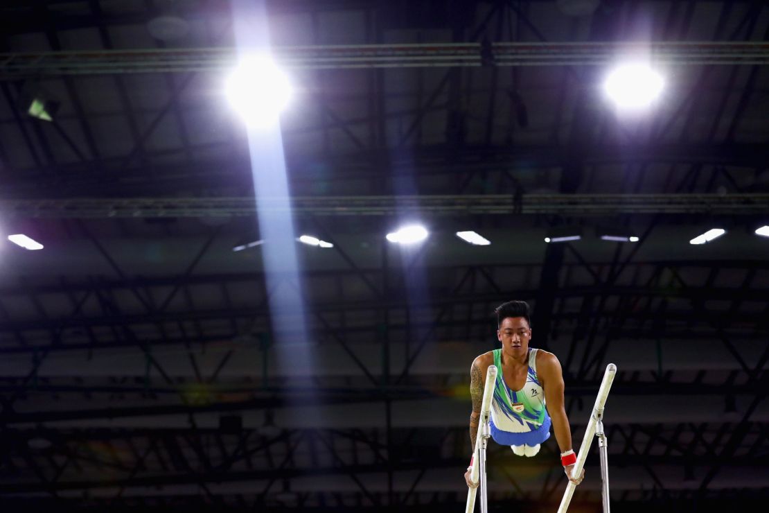 Cypriot gymnast Marios Georgiou on his way to victory in the men's parallel bars.