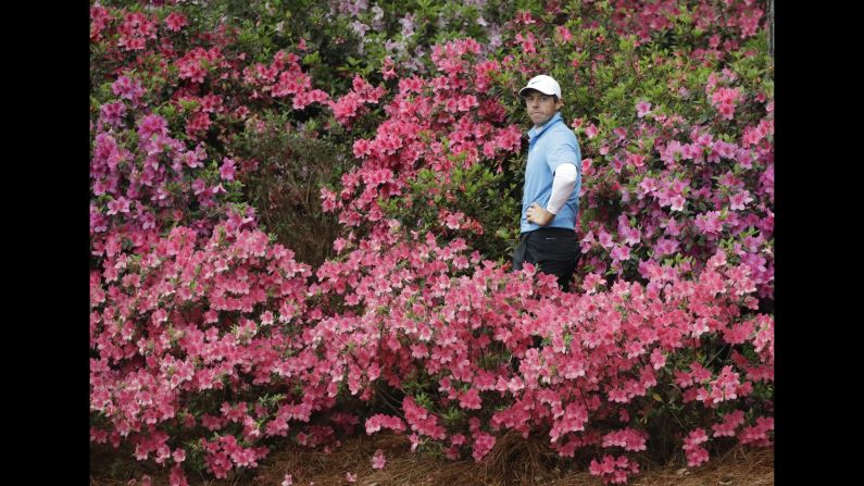 Rory McIlroy prepares to hit a shot out of some azaleas during the third round of the Masters on Saturday, April 7.