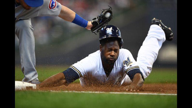 Milwaukee's Lorenzo Cain is tagged out at first base by the Chicago Cubs' Victor Caratini on Sunday, April 8. 
