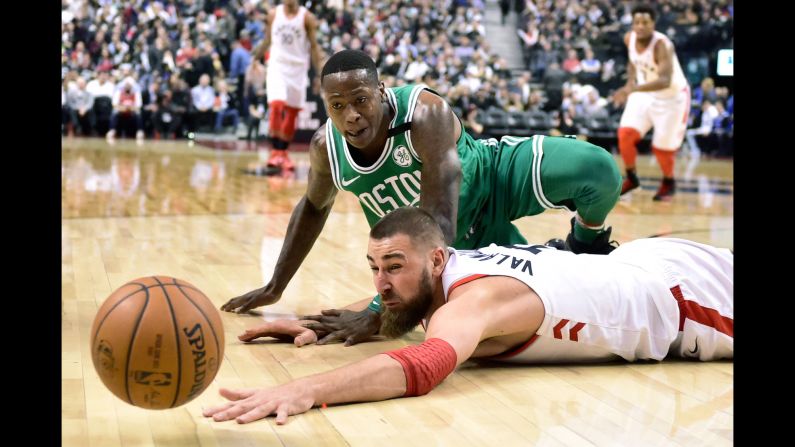 Boston's Terry Rozier, top, and Toronto's Jonas Valanciunas watch the ball get away from them during an NBA game on Wednesday, April 4.