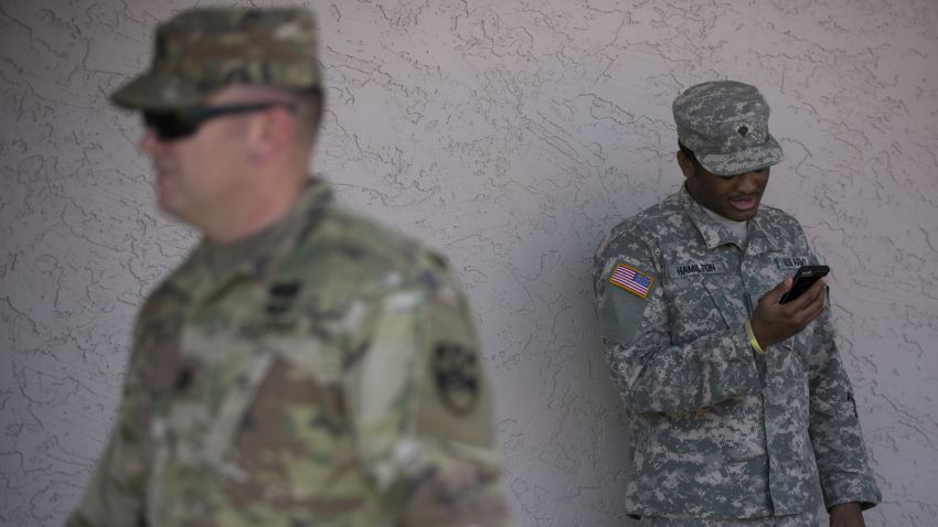 A member of the Arizona National Guard talks on the phone on April 9, 2018 at the Papago Park Military Reservation in Phoenix.Arizona deployed its first 225 National Guard members to the Mexican border on Monday after President Donald Trump ordered thousands of troops to the frontier region to combat drug trafficking and illegal immigration. "The Arizona National Guard will deploy 225 members of the Guard today to support border security measures," the state militia said in a statement. / AFP PHOTO / Caitlin O'Hara        (Photo credit should read CAITLIN O'HARA/AFP/Getty Images)