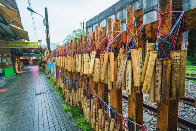 <strong>Bamboo wishes: </strong>For around $1, visitors can write a wish on a piece of bamboo, which is hung along a fence in the village. 