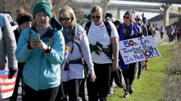 Lee Elementary School teacher Taylor Painter-Wolfe marches with a sign during the 7-day walk from Tulsa to the Oklahoma City. 