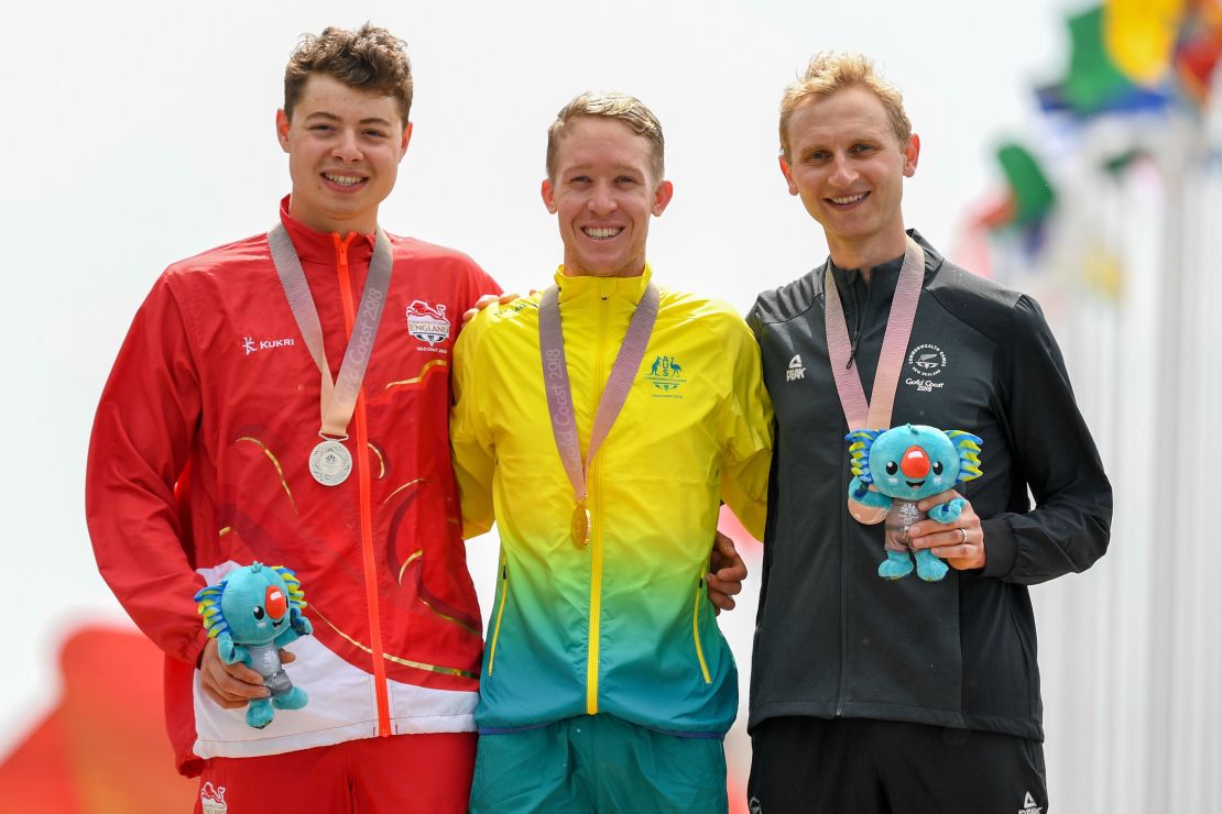 Bond (R) stands on the Gold Coast podium alongside Australia's Cameron Meyer and England's Harry Tanfield.