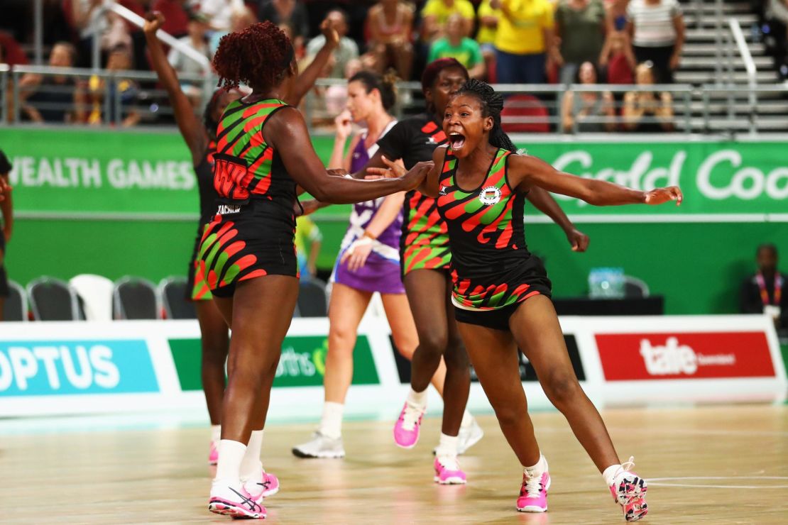 The Malawi netball team celebrate a climactic victory over Scotland on the Gold Coast.