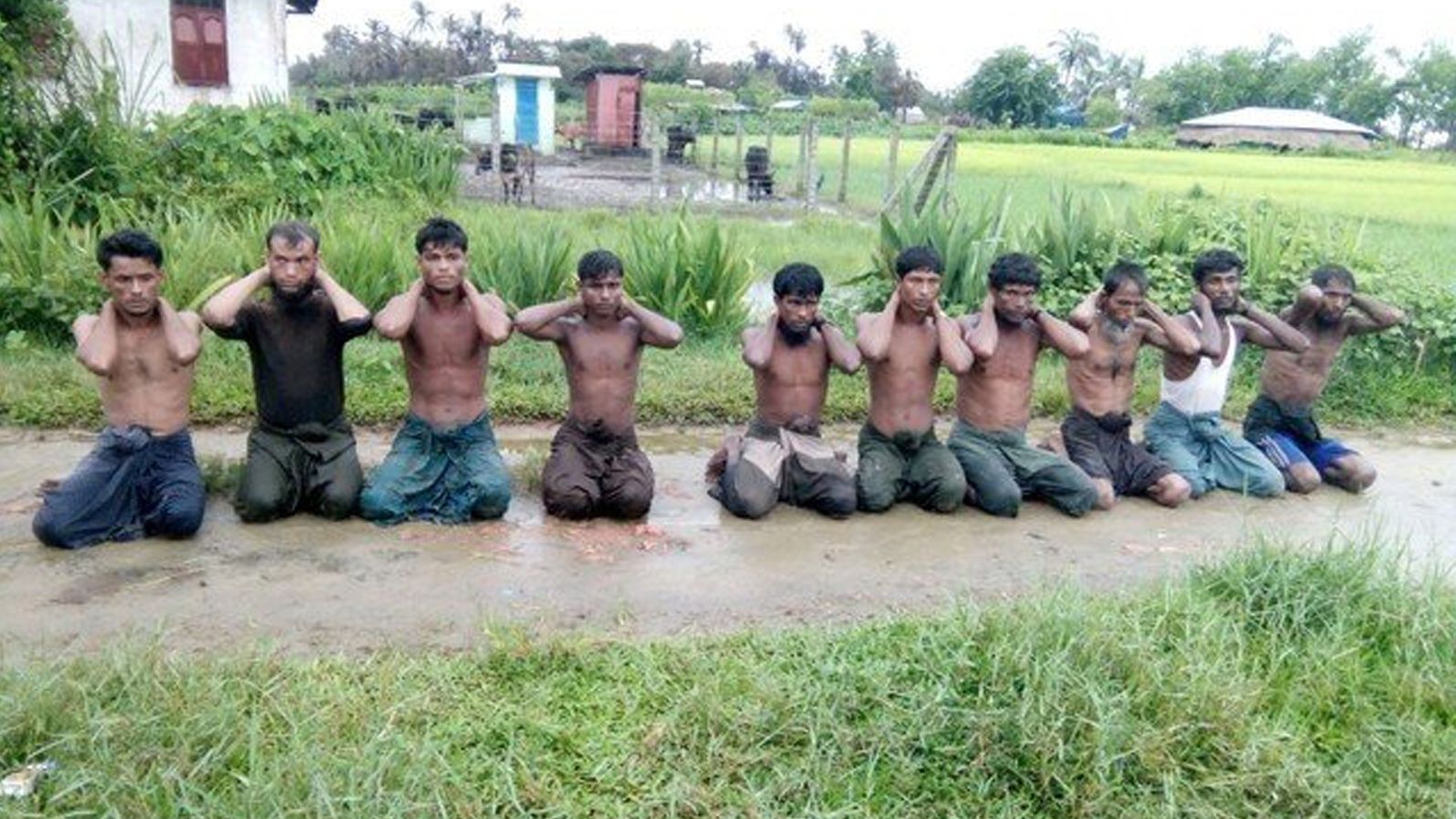 Ten Rohingya Muslim men with their hands bound kneel in Inn Din village September 1, 2017.