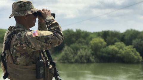A Texas National Guard member watching over the Rio Grande. 