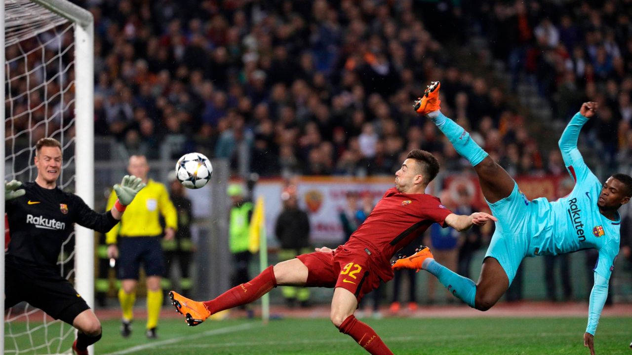 Barcelona goalkeeper Marc-Andre ter Stegen, left, saves as Roma's Stephan El Shaarawi, center, tries to score.