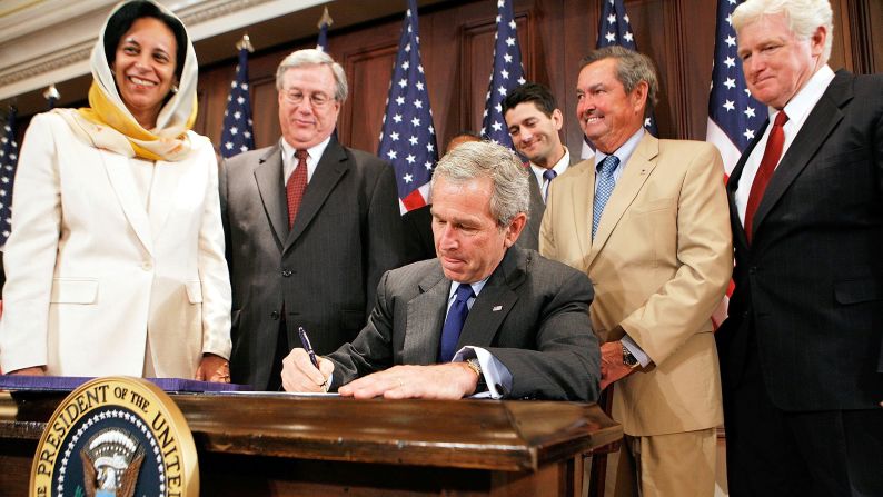 Ryan watches as President George W. Bush signs the United States-Oman Free Trade Agreement Implementation Act in 2006.