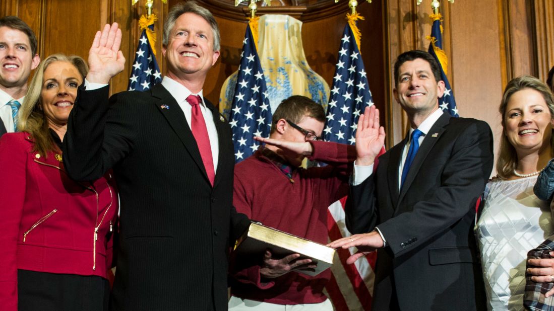 Ryan administers the oath of office to Rep. Roger Marshall in 2017 as one of Marshall's sons "dabs" during an unofficial ceremony.