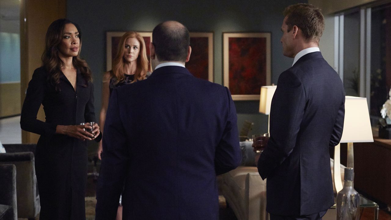 Gina Torres as Jessica Pearson, Sarah Rafferty as Donna Paulsen, and Gabriel Macht as Harvey Specter in "Suits."