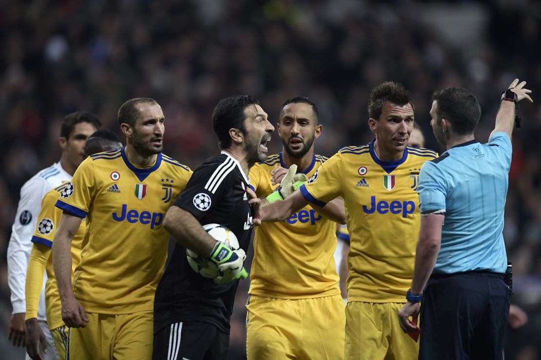 Juventus goalkeeper Buffon  argues with referee Michael Oliver following the award of a penalty to Real Madrid. 