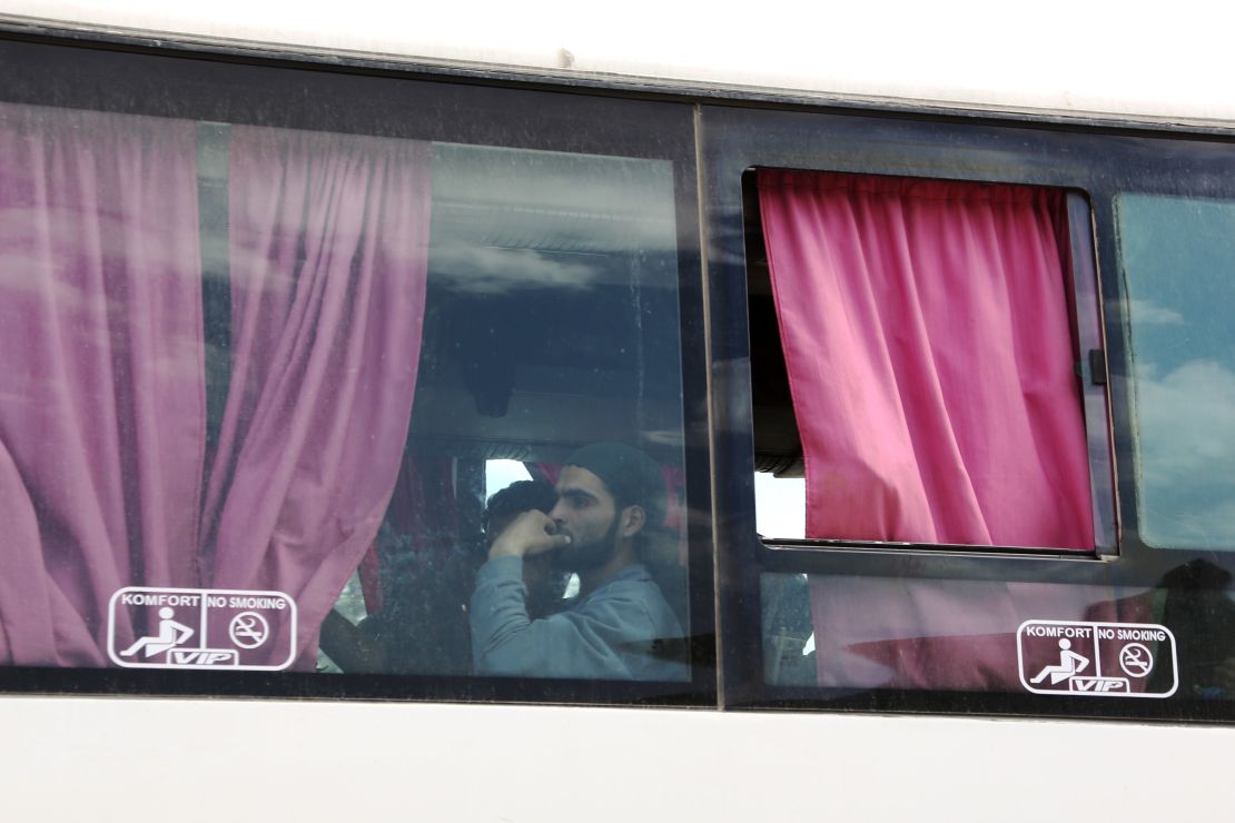 A Syrian man is seen aboard a bus carrying fighters and their families from their former rebel bastion of Douma as they arrive at the Syrian government-held side of the Wafideen checkpoint on the outskirts of Damascus.