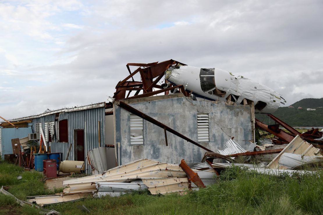 The wreckage of a plane lies on the roof of a destroyed building in Tortola, British Virgin Islands. 