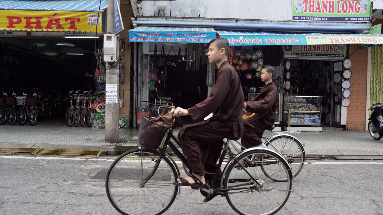 <strong>Religious cyclists: </strong>A pair of novice monks race through Hue's traffic -- just part of a thousand-strong squadron of urban cyclists.