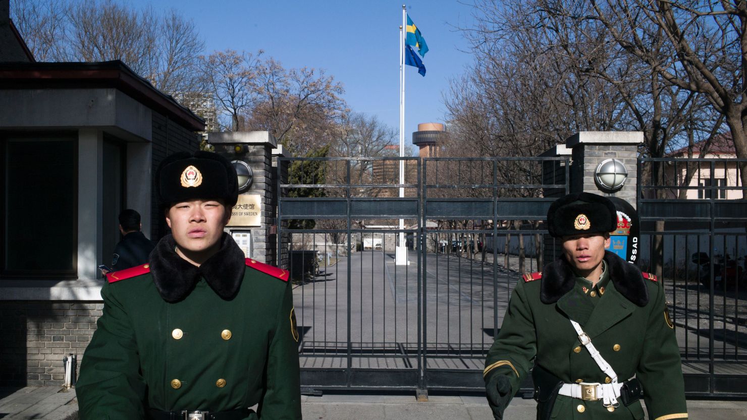 Paramilitary guards stand in front of the gates of Sweden's embassy in Beijing.