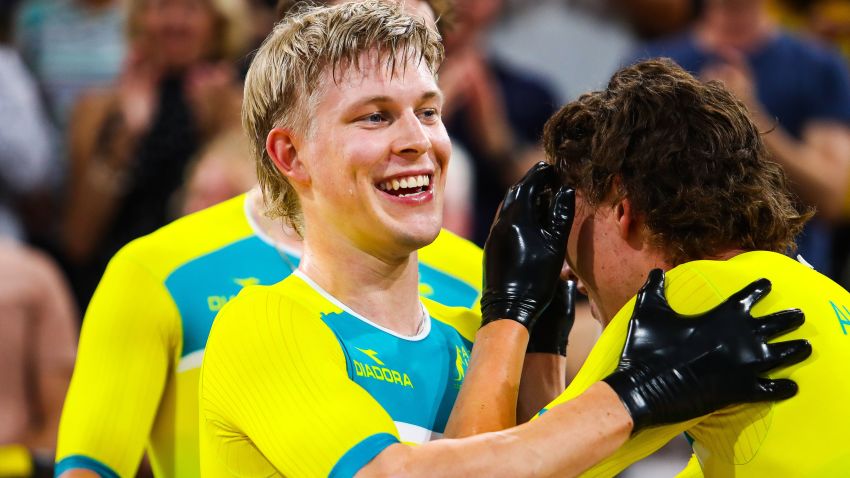 Australia's Alex Porter (C) celebrates victory with teammate Sam Welsford (R) following the Men's cycling 4000m Team Pursuit Final at the 2018 Gold Coast Commonwealth Games at the Anna Meares Velodrome in Brisbane on April 5, 2018.  / AFP PHOTO / Patrick HAMILTON        (Photo credit should read PATRICK HAMILTON/AFP/Getty Images)