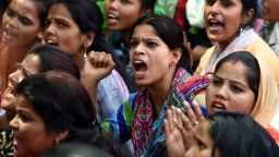 Indian women sit during a protest organised by 'Delhi Commission for Women' in New Delhi on April 13, 2018, outside Raj Ghat, memorial for Indian independence icon Mahatama Gandhi.
The brutal gang rape and murder of an eight-year-old girl in India has triggered nationwide outrage, inflamed communal tensions and shone a fresh critical light on the prevalence of sexual crimes. / AFP PHOTO / MONEY SHARMA        (Photo credit should read MONEY SHARMA/AFP/Getty Images)