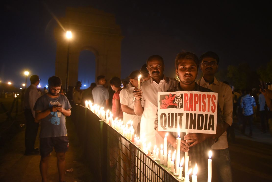 Indian demonstrators gather at the India Gate monument for a late night candlelight vigil in protest over the gang rape and murder of an eight-year-old girl, in New Delhi on April 13, 2018.