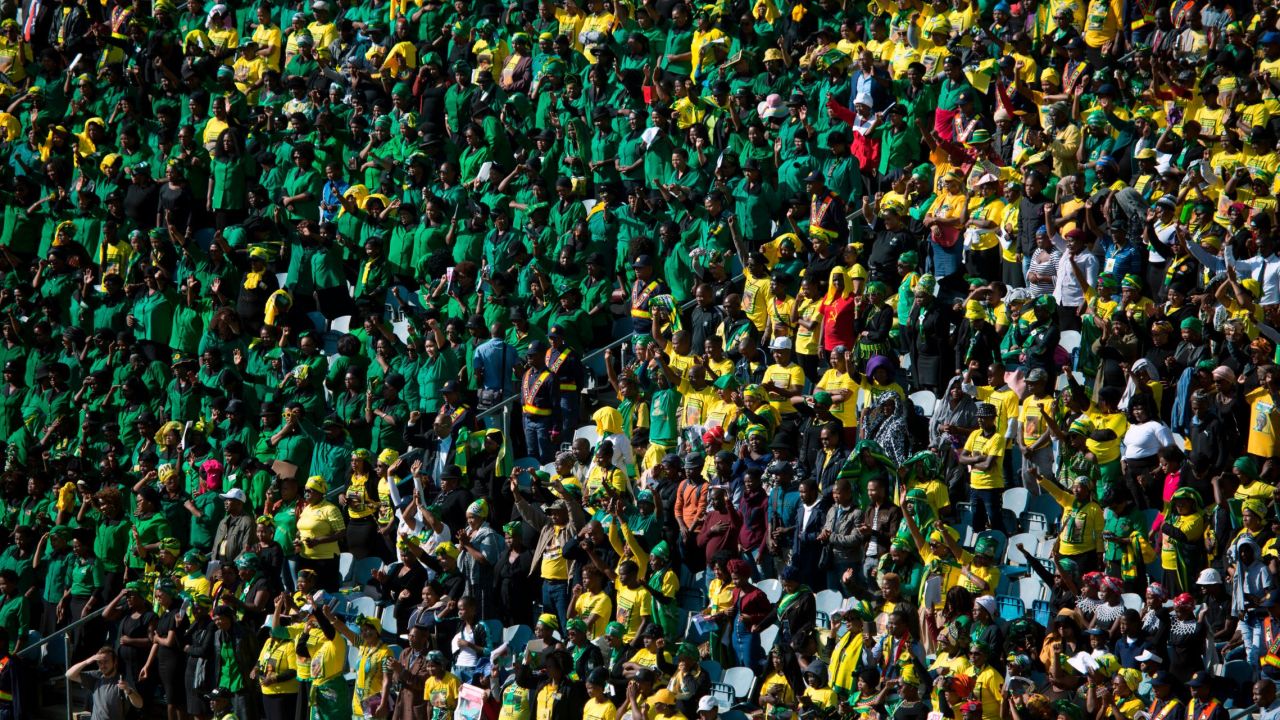 Mourners pack the stands at  Soweto's Orlando stadium for Saturday's funeral.